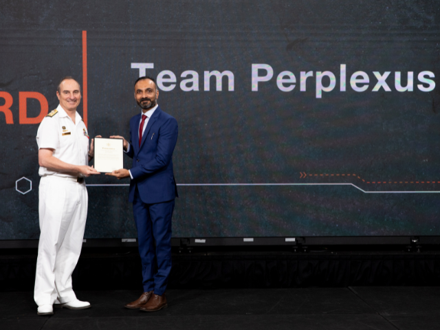 Team Perplexus representative Shyam Mehta receives his team’s 2024 VCDF Award from Vice Admiral David Johnston, AC, RAN.
