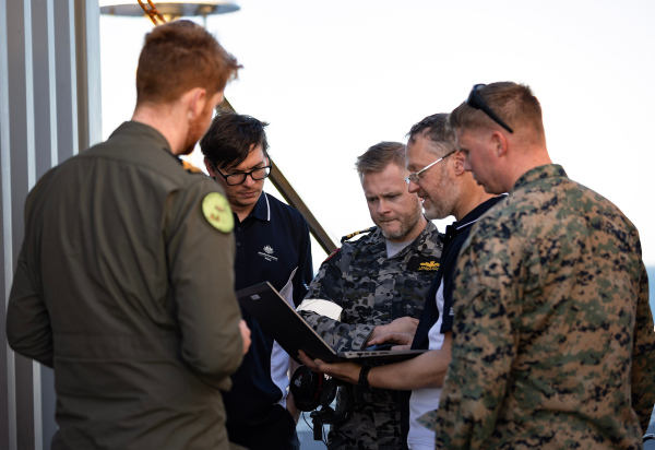 S100 Crew from 822X Squadron & DSTG scientists discuss the S100 Bathymetric LiDAR Sensor trials during Exercise Sea Raider 23.