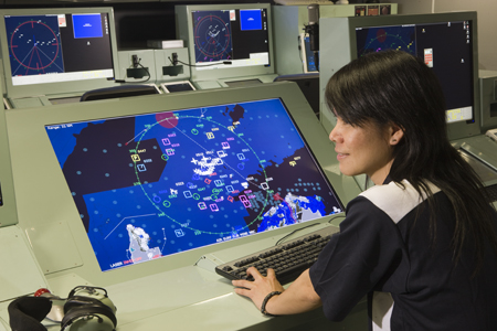 A photo of a DST Group researcher in the ANZAC Combat System Integration Laboratory.