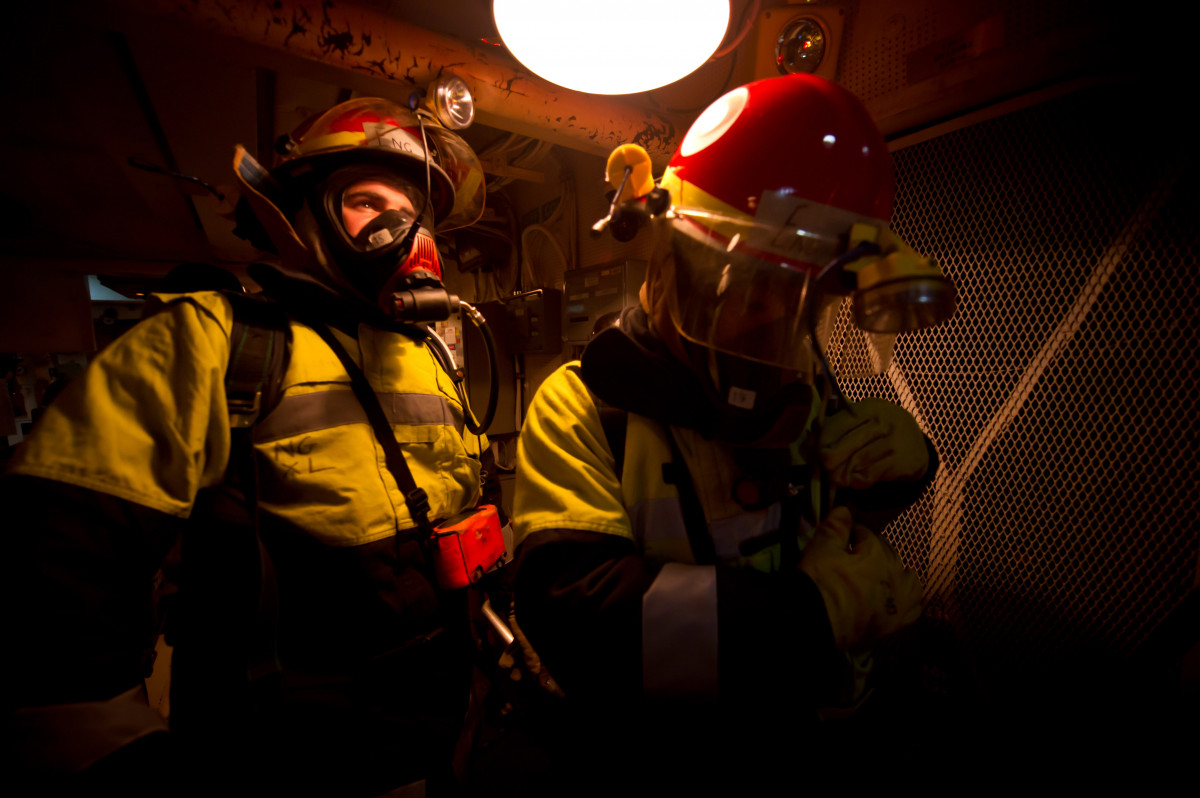 Sailors conducting fire drills aboard a frigate.