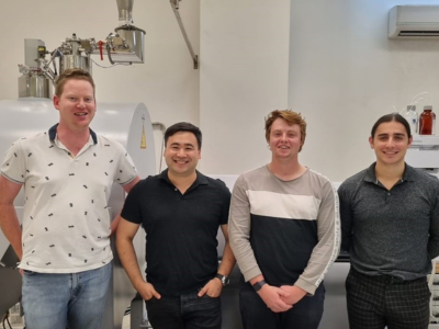 Scientists in a laboratory and smiling at camera