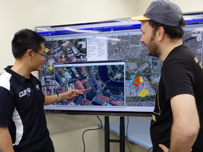 DST's Dr Lin Zhang demonstrates one of the new technologies being tested during CUE17 to Canadian researcher, Patrick Maupin.
