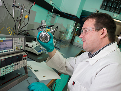 Defence Civilian Dr David Evans, Senior Chemistry Scientist from the Engines and Fuels Integrity department, prepares to calibrate a machine prior to testing in the Fuel and Lubricants Laboratory at the Defence Science and Technology Group facility, Fishermans Bend, Melbourne.