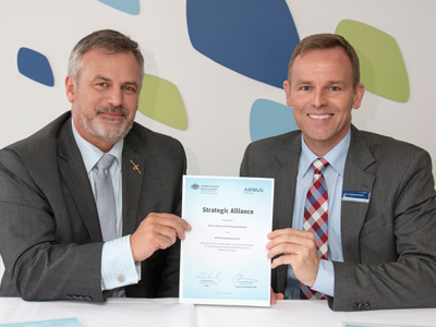 Chief Defence Scientist Dr Alex Zelinsky (left) and Airbus Group Australia Pacific Managing Director Dr Jens Goennemann (right) holding the newly signed strategic alliance.