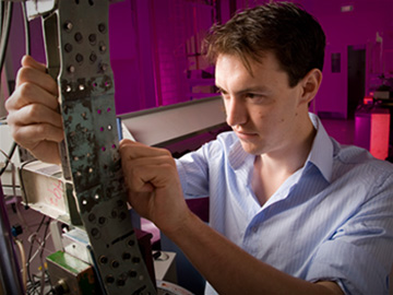 A young scientist records data from test equipment.