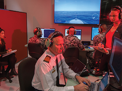 DST researchers working alongside Navy personnel in the Combat System Integration Laboratory, exploring UAS integration into RAN ships.