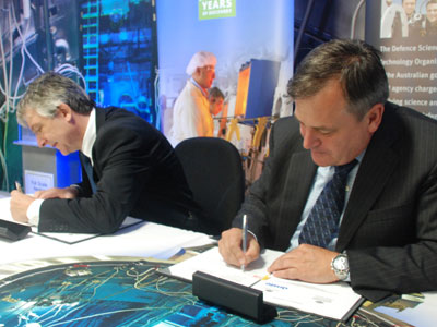 Chief Defence Scientist Alex Zelinsky and ANSTO CEO Adi Paterson (left) sign an agreement of cooperation 
