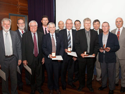 Bruce Ward, Gordon Frazer, Justin Praschifka, Don Sinnott, Malcolm Golley, Minister for Defence Science and Personnel Warren Snowdon. Front row: Warwick Kemp, Gordon Brimble, Steve Sheedy, Neil Bryans, Mike Turley, Stuart Anderson with their awards