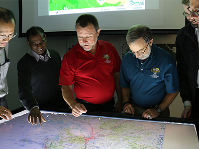 Researchers examining the DST-developed joint Seminar Wargame Adjudication Tool. Researchers examining the DST-developed joint Seminar Wargame Adjudication Tool.