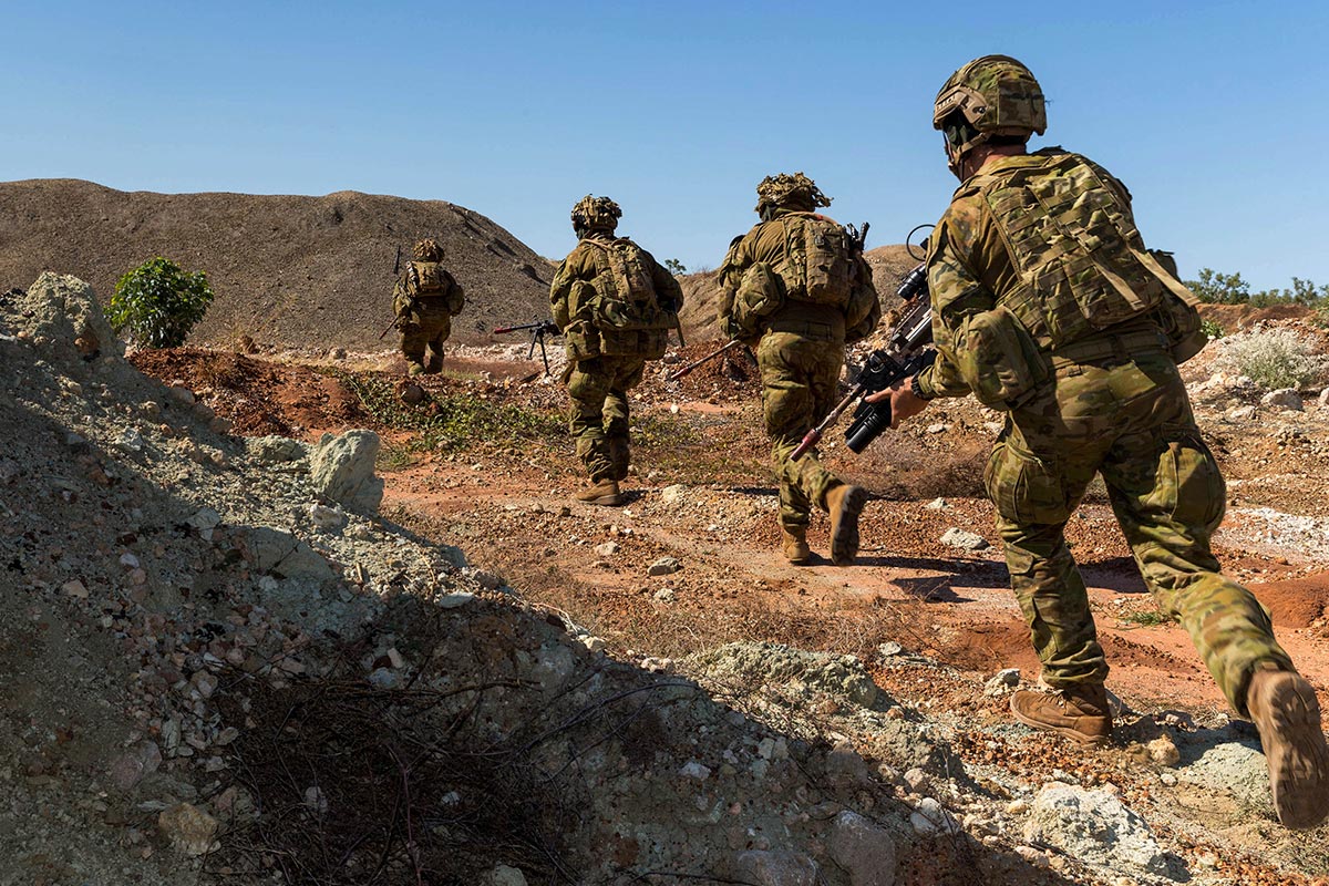 Australian soldiers running while on exercise.