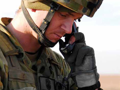 A soldier speaking on a wireless telephone