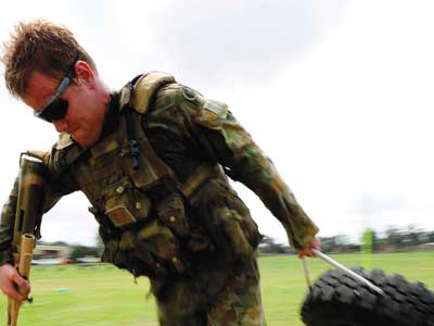 A soldier dragging along a tyre as part of an exercise.