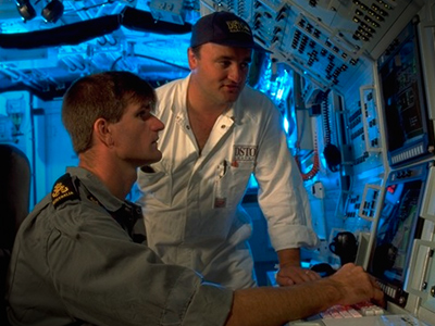 Picture showing Australian Naval Ships' officers looking at an undersea computer system 