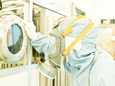 An image of a scientist with protective clothing.
