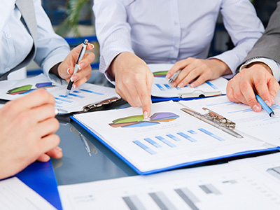 DSTO's first National Security Science and Technology Workshop took place on 27 November in Canberra. Stock image of hands pointing at documents.