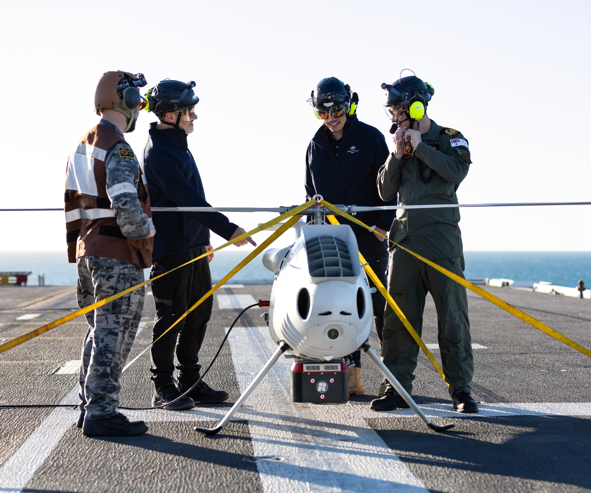 S100 Crew from 822X Squadron and Defence Science and Technology Group personnel discuss the S100 Bathymetric LiDAR Sensor trials on the Flight Deck of HMAS Adelaide during Exercise Sea Raider 23. It saw the Australian Amphibious Force train closely with the Royal Australian Navy's HMAS Adelaide and HMAS Choules, as well as a beach landing force comprising of infantry, armoured vehicles, artillery, aviation and logistic elements optimised for amphibious raids and assaults.