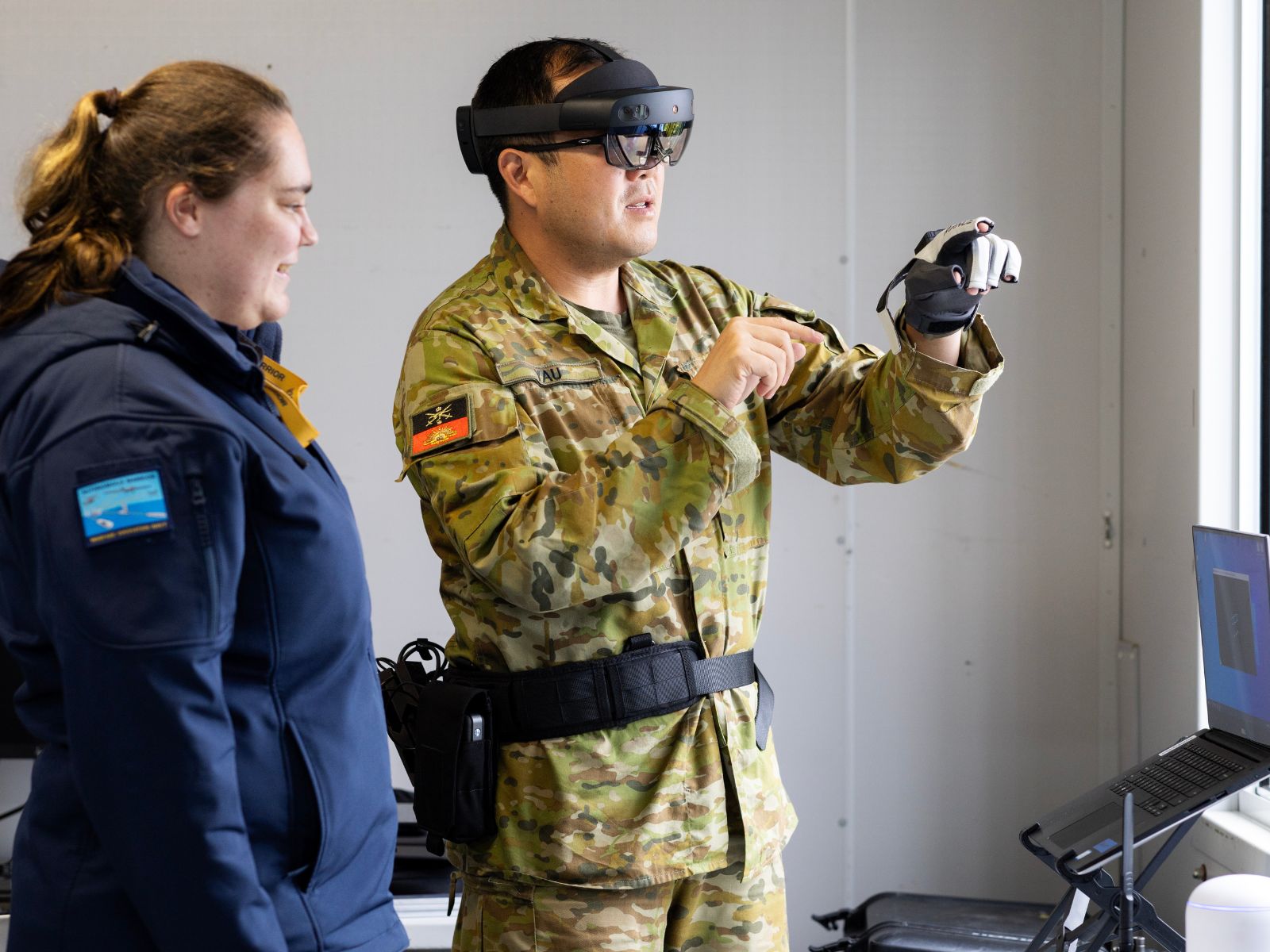 Caitlyn Sims and Major Ivan Yau demonstrate Multimodal Edge 4 (MEC4) during the Technical Cooperation Program AI Strategic Challenge 2023 at HMAS Creswell, Jervis Bay Territory.