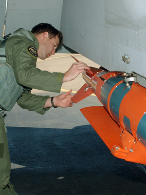 An image of a pilot inspecting a glide bomb.