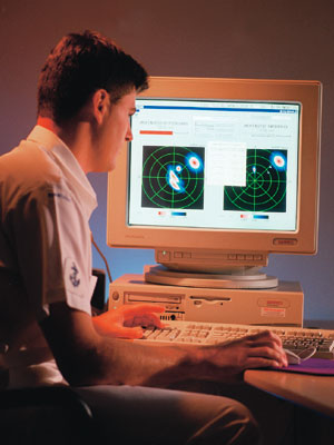 A photograph of a man looking at a computer screen displaying MEXANS software