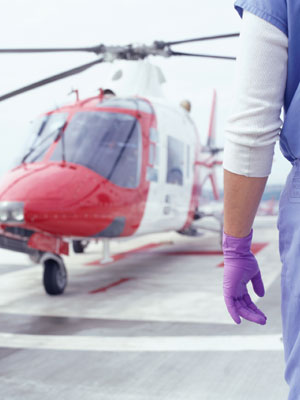 A stock image of a doctor waiting on tarmac for a aeromed helicopter.