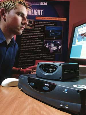 Photograph of a man seated at a computer with the Starlight box beside him.