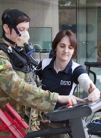 A photograph of a female soldier on a treadmill with a DSTG scientist alongside.