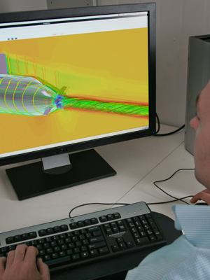 An image of a man looking at a computer image of a submarine.