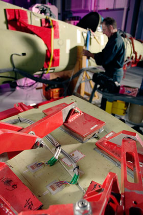 An engineer preparing the Hawk Lead-in Fighter rig.