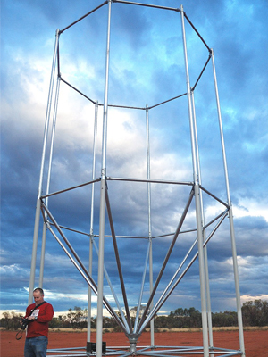 An image of a man in front of a radar array.