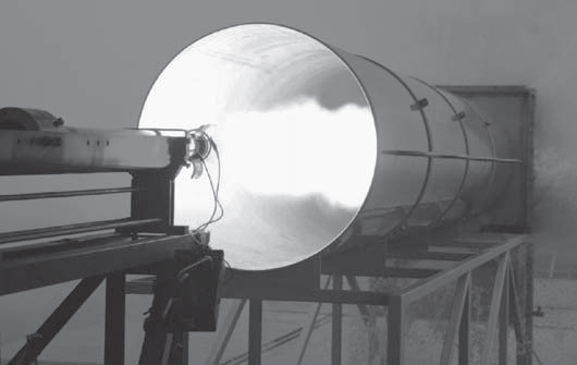 A photograph of a static firing in DST Group's rocket motor test facility.