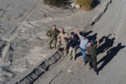 Bin Lee (centre) with four DRDC colleagues testing the new CADPAT (MT) uniform and other developmental materials at 29 Palms, California in November 2022.The Marine Corps Air Ground Combat Center (MCAGCC), also known as 29 Palms, is the largest United States Marine Corps base.