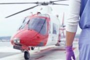 A stock image of a doctor waiting on tarmac for a aeromed helicopter.