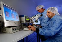 Two DST Group scientists conduct laser micro machining.