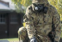 An image of a person wearing protective clothing handling a box containing hazardous materials.