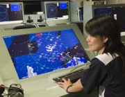 A photo of a DST Group researcher in the ANZAC Combat System Integration Laboratory.