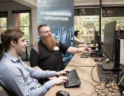 Mr Tim Pitts (DSTG) chats to IW Scholarship student Ethan Selway (University of Adelaide). 