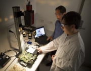 DST scientists Jay Yu (foreground) and Bin Lee using a benchtop hyperspectral imaging camera to conduct material reflectance property measurements.