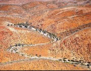Aerial view of the Northern Flinders Ranges containing incised creek valleys and gorges where Warratyi Rock Shelter was discovered. Photo attribution: Giles Hamm Aerial view of the Northern Flinders Ranges containing incised creek valleys and gorges where Warratyi Rock Shelter was discovered.