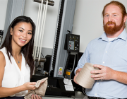 Vanessa Ha and Mark Ryan with the equipment used to stretch the yarn samples used in their shape-memory polymer research. 