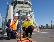 Image of Dr Andrew Ang and Mr Matthew Leigh preparing for the on-board trials on HMAS Canberra.