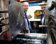 Jim Grose (left), Managing Director of Axiom, and Ben Barona, from DST, examining the injection moulding die being used to produce face shield headbands.