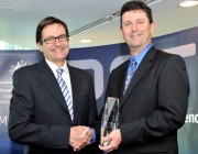 Greg Combet shaking hands with Dr Gordon Frazer after presenting him with his award.