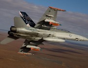 A Royal Australian Air Force F/A-18 Hornet in flight with two JDAM-ER 500lb bombs and two Time Space Position Information pods.
