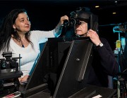 Maria Gavrilescu and Peter Gibbs prepare to conduct an experiment on visual performance with a night vision device used in Army aviation.