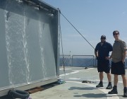 Shannon Keough and Ian Kermonde on the deck of the Greek vessel HS Prometheus, with the DST Containerized Washdown System. Shannon Keough and Ian Kermonde on the deck of the Greek vessel HS Prometheus, with the Wandjina test article.