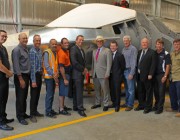 A photograph of the Minister for Defence Science and Personnel standing with DSTO personnel in front of the model of the Joint Strike Fighter.