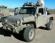 A modified Jeep fitted with a DST Satellite-On-The-Move (SOTM) unit (the dome on the rear tray).