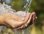 An image of water flowing onto cupped hands.