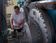An image of a man working on a compressor in the Combustion Test Facility