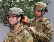 Solider placing fight recorder on fellow solider